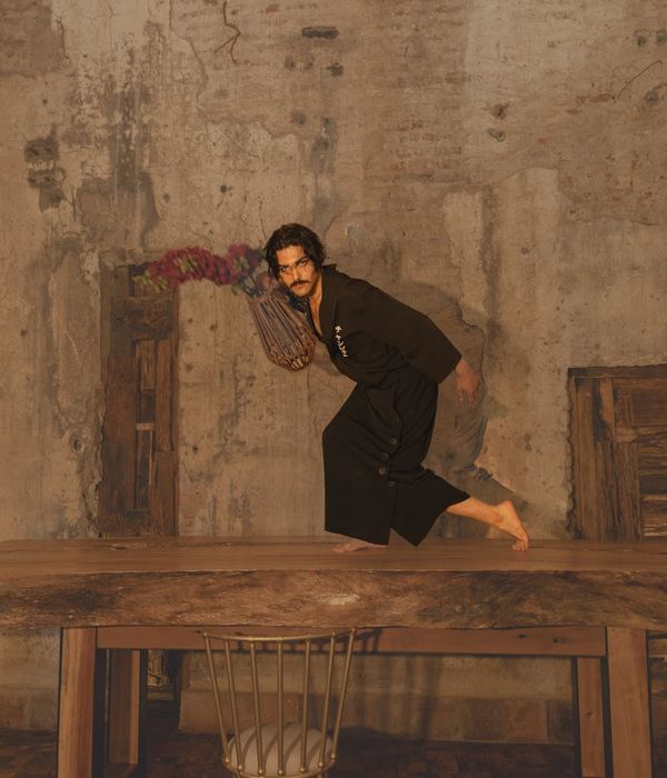 Man practicing stability movements in a dark studio